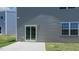 Exterior backyard view with sliding glass doors and a concrete patio at 236 Moore Creek Dr, Fuquay Varina, NC 27526
