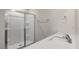 Bathroom detail showing quartz countertop, sink and shower with glass doors at 236 Moore Creek Dr, Fuquay Varina, NC 27526