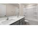 Bathroom with double vanity, white countertops, and a bathtub/shower combo at 236 Moore Creek Dr, Fuquay Varina, NC 27526