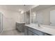 Bathroom featuring dual gray vanities, quartz countertop and walk-in shower at 236 Moore Creek Dr, Fuquay Varina, NC 27526