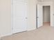 Bedroom with neutral carpet, two white doors at 236 Moore Creek Dr, Fuquay Varina, NC 27526