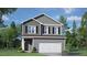 Charming two-story home with gray siding, black shutters, and a two-car garage at 236 Moore Creek Dr, Fuquay Varina, NC 27526