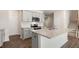 Bright kitchen boasts stainless appliances, white cabinets, and a large center island at 236 Moore Creek Dr, Fuquay Varina, NC 27526