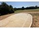 View of large backyard with manicured lawn, mature trees and partial concrete slab at 280 Forest Bridge Rd, Franklinton, NC 27525