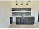 Stylish bar area with unique patterned backsplash, open shelving and wood cabinets at 280 Forest Bridge Rd, Franklinton, NC 27525