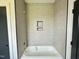 Bathroom featuring a new tub, custom tile, and sleek fixtures, perfect for relaxation at 280 Forest Bridge Rd, Franklinton, NC 27525