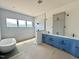 Modern bathroom featuring a soaking tub, a walk-in glass shower, and sleek double vanities at 280 Forest Bridge Rd, Franklinton, NC 27525