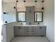 Modern bathroom with double vanity, gray cabinets, sleek black fixtures, and a glass-enclosed shower at 280 Forest Bridge Rd, Franklinton, NC 27525