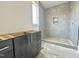 An in-progress bathroom featuring a tiled shower, cabinet, and a window at 280 Forest Bridge Rd, Franklinton, NC 27525