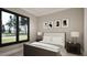 Tranquil bedroom with a large window view, modern decor, and comfortable furnishings at 280 Forest Bridge Rd, Franklinton, NC 27525
