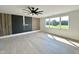 Generous room with sleek floors, black feature wall, and large windows that offer stunning green outdoor views at 280 Forest Bridge Rd, Franklinton, NC 27525