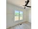 Bright bedroom featuring a modern ceiling fan and large window with a pleasant outdoor view at 280 Forest Bridge Rd, Franklinton, NC 27525