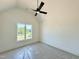 Bright bedroom featuring a ceiling fan and large window offering abundant natural light and scenic outdoor views at 280 Forest Bridge Rd, Franklinton, NC 27525