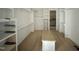 Bright walk-in closet with custom-built shelving, a center island, and hardwood floors for organized storage at 280 Forest Bridge Rd, Franklinton, NC 27525