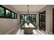 Well-lit dining room showcasing large windows, a modern light fixture, and a spacious table perfect for entertaining at 280 Forest Bridge Rd, Franklinton, NC 27525