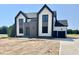 Striking modern home featuring a contrasting black and white color scheme and impeccable architectural design at 280 Forest Bridge Rd, Franklinton, NC 27525