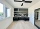 Well-lit home office featuring built-in desk and shelving along accent wall, plus a modern ceiling fan at 280 Forest Bridge Rd, Franklinton, NC 27525