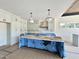 Bright kitchen featuring white cabinets, island, modern pendant lights, and stainless steel appliances at 280 Forest Bridge Rd, Franklinton, NC 27525