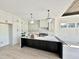 Bright kitchen featuring white cabinets, a marble backsplash, a large island, and modern pendant lighting at 280 Forest Bridge Rd, Franklinton, NC 27525