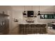 Bright, modern kitchen with white cabinetry, marble backsplash, island with seating, and stainless steel appliances at 280 Forest Bridge Rd, Franklinton, NC 27525