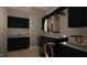 This laundry room features dark cabinets, gray countertops, and washer and dryer at 280 Forest Bridge Rd, Franklinton, NC 27525