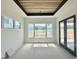 Bright living room boasts large windows, modern doors, and wood-look ceiling for natural light at 280 Forest Bridge Rd, Franklinton, NC 27525