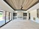 Spacious living room with wood floors, wood paneled ceiling, sliding glass doors, and a modern fireplace at 280 Forest Bridge Rd, Franklinton, NC 27525