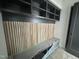 Mudroom features custom shelving, cabinets, wood accent wall, and a bench for practical storage and organization at 280 Forest Bridge Rd, Franklinton, NC 27525