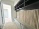 Mudroom entry offers custom bench and storage system with wood accent and storage shelves at 280 Forest Bridge Rd, Franklinton, NC 27525