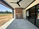 Outdoor patio with brick fireplace, ceiling fan, and tile flooring at 280 Forest Bridge Rd, Franklinton, NC 27525