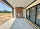 Covered patio with stone flooring, brick fireplace, and sliding glass doors offer a stylish outdoor space at 280 Forest Bridge Rd, Franklinton, NC 27525