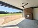 Covered patio with a brick fireplace and a ceiling fan, perfect for outdoor relaxation and entertainment at 280 Forest Bridge Rd, Franklinton, NC 27525