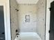 Bathroom shower area features a tub, grey hexagonal tile, and black hardware, including a shower head at 280 Forest Bridge Rd, Franklinton, NC 27525