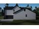 Home exterior showing the side of the house and garage, with dark trim and white siding at 280 Forest Bridge Rd, Franklinton, NC 27525