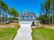 Inviting two-story home with blue siding, white trim, and green lawn at 121 Plainfield Ln # 134, Lillington, NC 27546