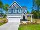 Two-story home showcasing a two-car garage, and a well-manicured lawn at 121 Plainfield Ln # 134, Lillington, NC 27546