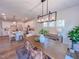 Open floor plan with the dining room adjacent to kitchen space featuring white cabinets and stainless appliances at 121 Plainfield Ln # 134, Lillington, NC 27546