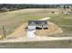 Expansive aerial view of a charming white home surrounded by a sprawling green landscape at 233 Surles Rd, Benson, NC 27504