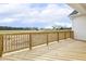 Back deck with wooden planks and railings overlooking a large grassy area at 233 Surles Rd, Benson, NC 27504