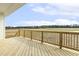 New wood deck with railings overlooking a large yard and distant treeline at 233 Surles Rd, Benson, NC 27504