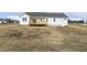 New construction home showcasing a wooden deck and spacious backyard at 233 Surles Rd, Benson, NC 27504