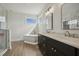 Bright bathroom with a soaking tub, standalone shower, and double sink vanity with granite countertop at 233 Surles Rd, Benson, NC 27504
