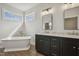 Bright bathroom with a soaking tub and double sink vanity with granite countertop, and bright lighting at 233 Surles Rd, Benson, NC 27504