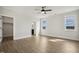 Spacious bedroom with ceiling fan, closet, en suite bath, and natural light from two windows at 233 Surles Rd, Benson, NC 27504