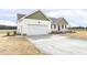 Charming single-story home with a two-car garage, green trim, and freshly laid mulch at 233 Surles Rd, Benson, NC 27504