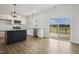 Modern kitchen with stainless appliances, granite counters, island, and access to outdoor deck at 233 Surles Rd, Benson, NC 27504
