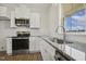 Modern kitchen with stainless appliances, granite countertops, island, and lots of natural light at 233 Surles Rd, Benson, NC 27504