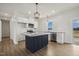 Modern kitchen with stainless appliances, island, granite countertops, and subway tile backsplash at 233 Surles Rd, Benson, NC 27504