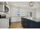 Modern kitchen featuring stainless appliances, granite counters, subway tile, and sleek cabinetry at 233 Surles Rd, Benson, NC 27504