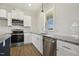 Modern kitchen with stainless appliances, granite countertops, island, and lots of natural light at 233 Surles Rd, Benson, NC 27504
